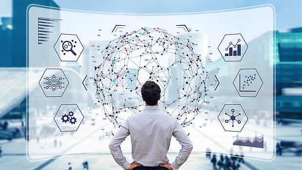 Requirement Analysis & Concept Design – Learn More (Image Link) A consultant analyzing a digital network model, representing LS telcom’s approach to requirement analysis and concept design for tailored communication networks. Click to learn more.