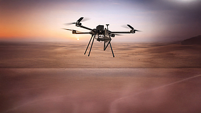 Drone-based airborne monitoring unit for military spectrum monitoring above desert terrain.